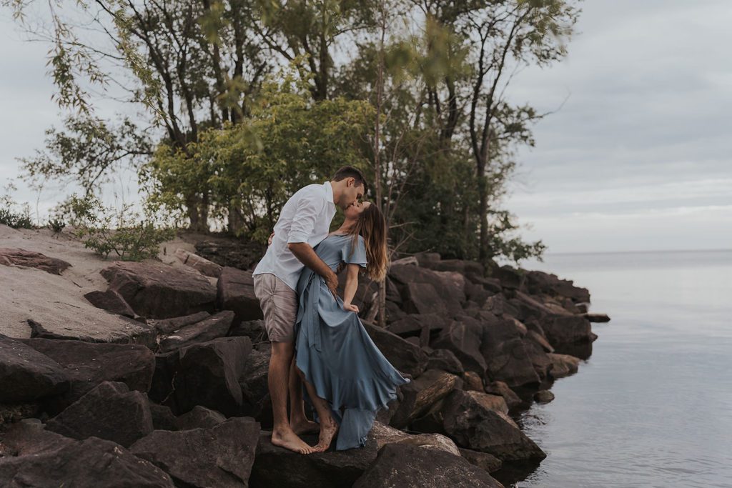 fiance kissing his girl friend and dipping her backwards for their engagement session photos