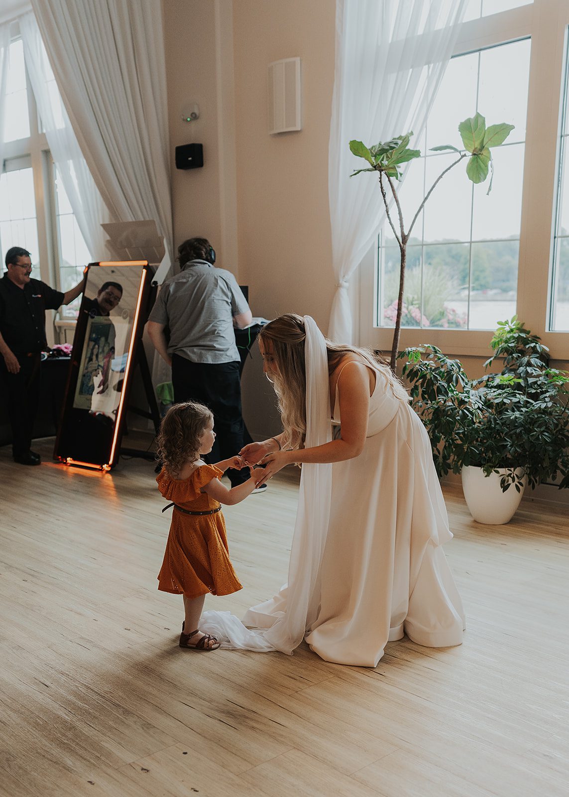 bride dancing with little girl at reception