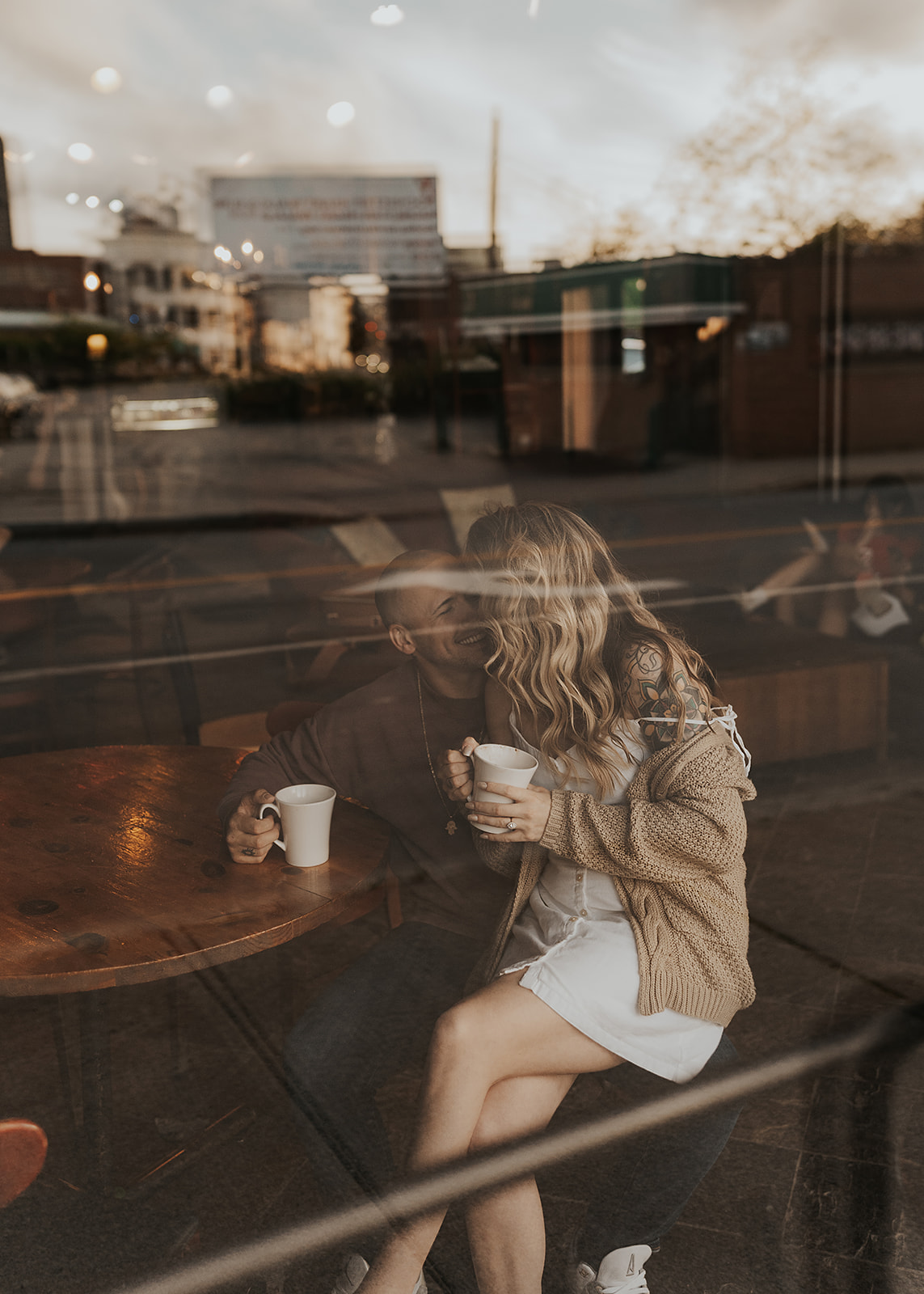 photo of couple sitting in a coffee shop through the window