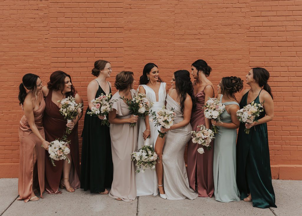 bride and her bridesmaids laughing during their bridal party photos in rochester ny 