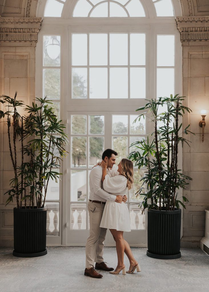 engaged couples standing in the garden of the hermitage hotel during their destination engagement photoshoot in Tennessee