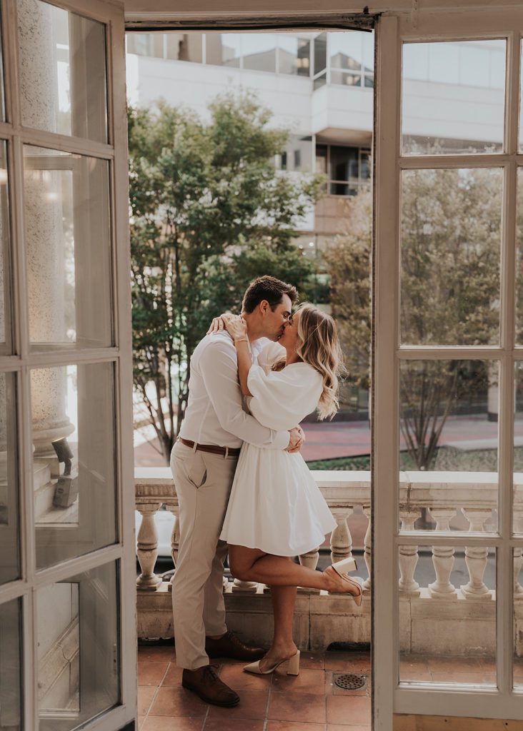 engaged couples kissing on the patio of the beautiful  Hermitage Hotel