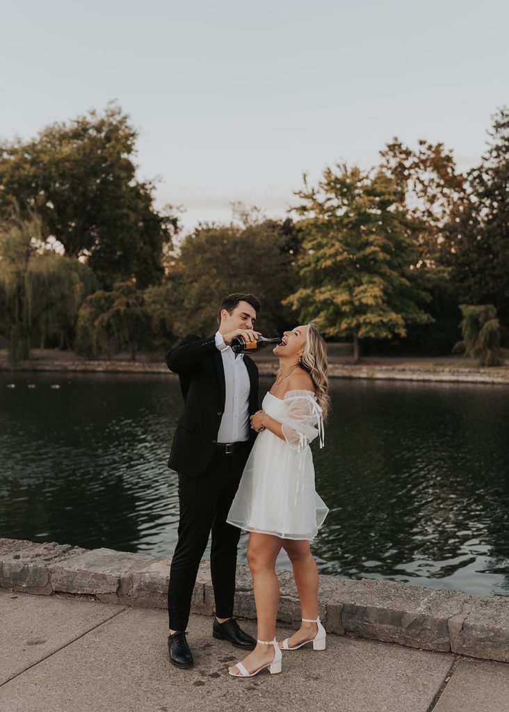 fiancé fountaining champagne into his girl friends mouth during their destination engagement photos
