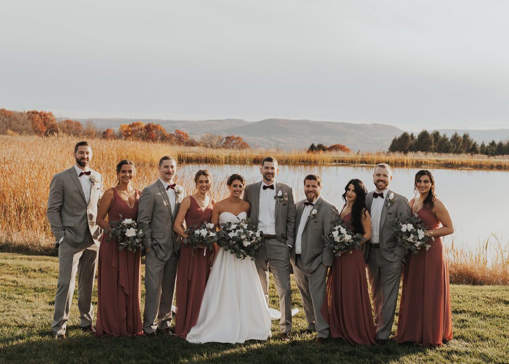 bride and groom with their bridal party at wrens roost wedding venue in rochester ny