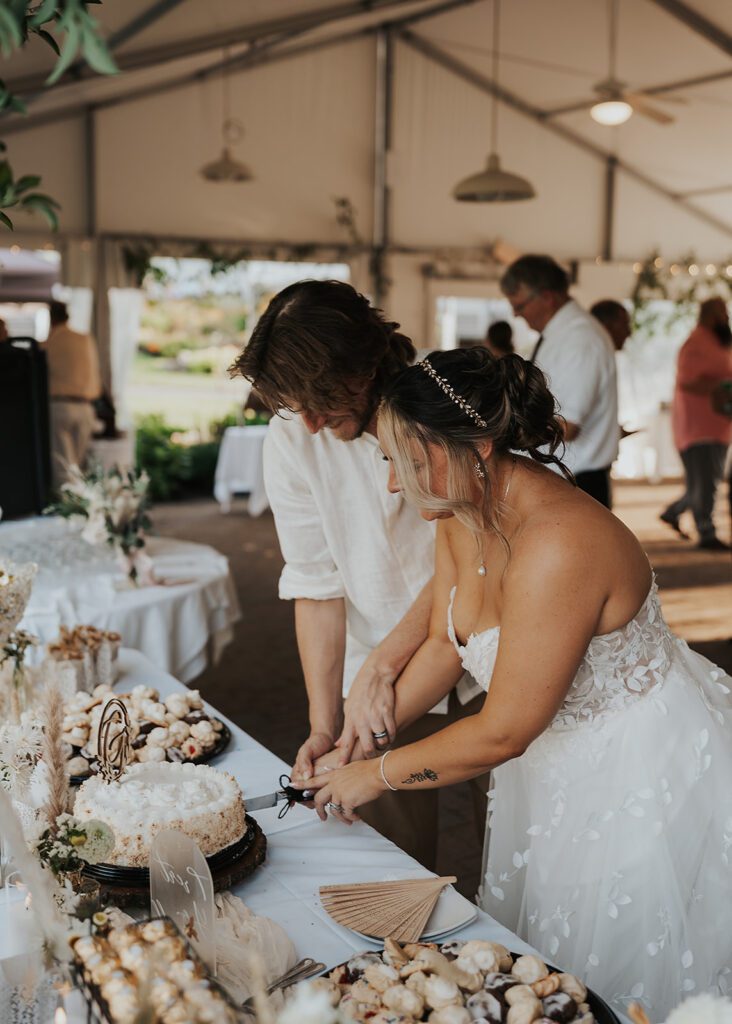 bride and groom cutting their cake during their reception in jamaica
