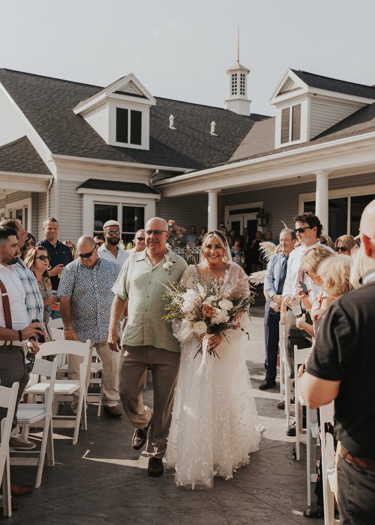 bride walking down the aisle with her dad during her wedding in jamaica