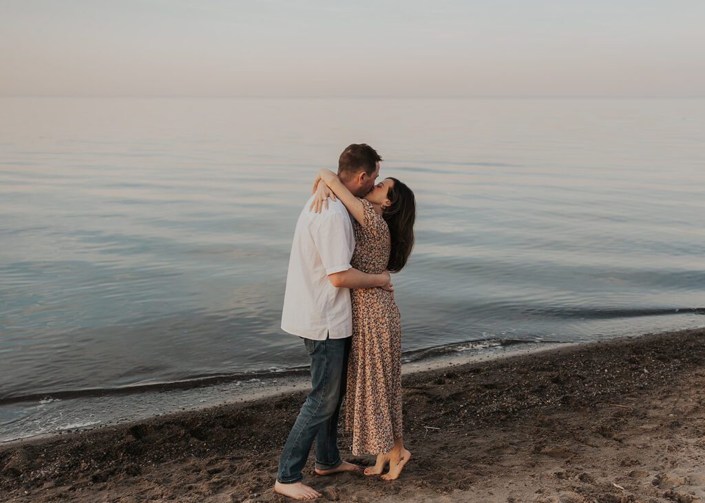 boho couple kissing on the beach during their baby announcement photoshoot in Columbus ohio